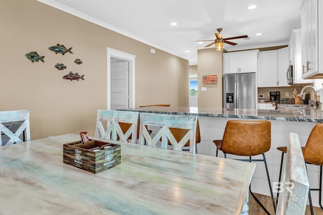 566 Boykin Ct N, Gulf Shores, AL 36542 - dining space with ornamental molding, a ceiling fan, and recessed lighting