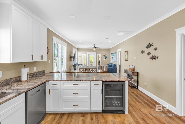 566 Boykin Ct N, Gulf Shores, AL 36542 - kitchen with beverage cooler, dishwasher, a peninsula, white cabinetry, and light wood-type flooring