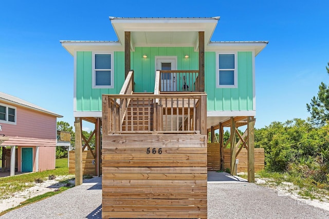 566 Boykin Ct N, Gulf Shores, AL 36542 - beach home with board and batten siding, stairs, and metal roof