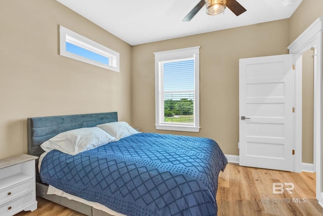 566 Boykin Ct N, Gulf Shores, AL 36542 - bedroom with light wood finished floors, baseboards, and a ceiling fan