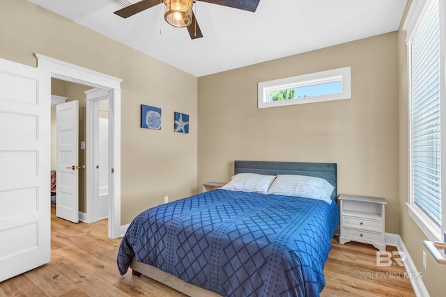566 Boykin Ct N, Gulf Shores, AL 36542 - bedroom with wood finished floors, baseboards, and a ceiling fan