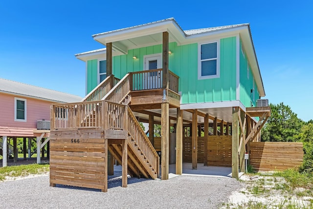 566 Boykin Ct N, Gulf Shores, AL 36542 - view of front of house with a carport, board and batten siding, metal roof, and central AC