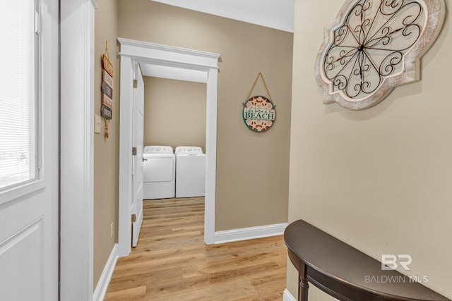 566 Boykin Ct N, Gulf Shores, AL 36542 - corridor featuring light wood finished floors, washing machine and clothes dryer, and baseboards