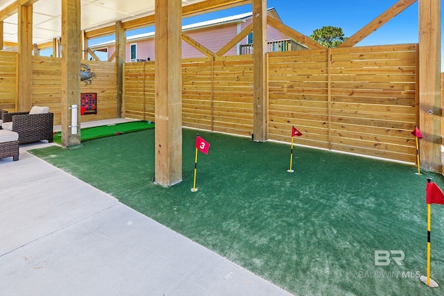 566 Boykin Ct N, Gulf Shores, AL 36542 - view of playground with fence and an area to practice putting