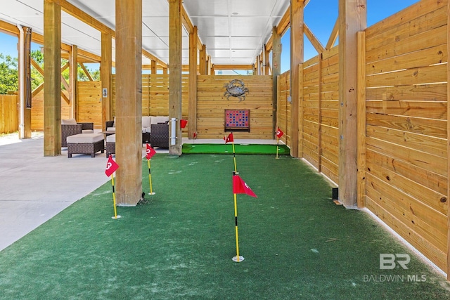 566 Boykin Ct N, Gulf Shores, AL 36542 - view of home's community with a putting green and outdoor lounge area