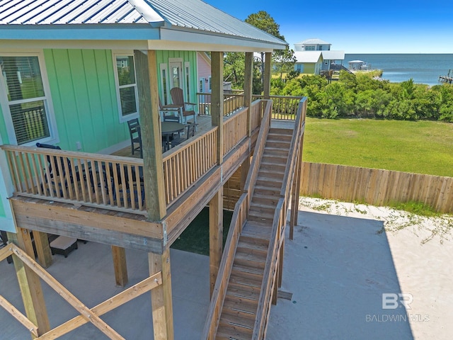 566 Boykin Ct N, Gulf Shores, AL 36542 - wooden deck with a water view, a yard, and stairs
