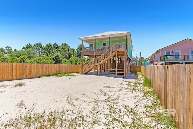 566 Boykin Ct N, Gulf Shores, AL 36542 - rear view of property with stairs, a fenced backyard, and metal roof