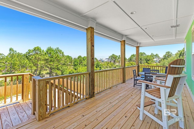 566 Boykin Ct N, Gulf Shores, AL 36542 - wooden deck featuring view of scattered trees