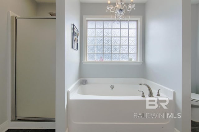 bathroom with a chandelier, toilet, and independent shower and bath