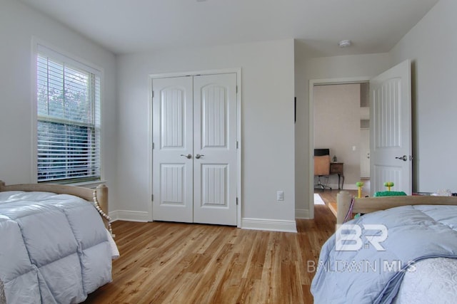 bedroom featuring a closet and light hardwood / wood-style flooring