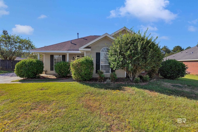 obstructed view of property featuring a front yard and fence