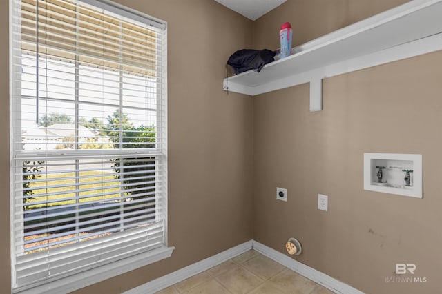 clothes washing area with hookup for a washing machine, light tile patterned floors, baseboards, laundry area, and electric dryer hookup