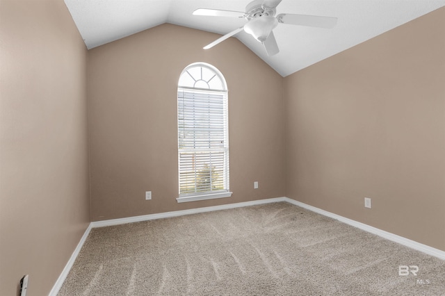 unfurnished room with baseboards, lofted ceiling, carpet floors, and ceiling fan