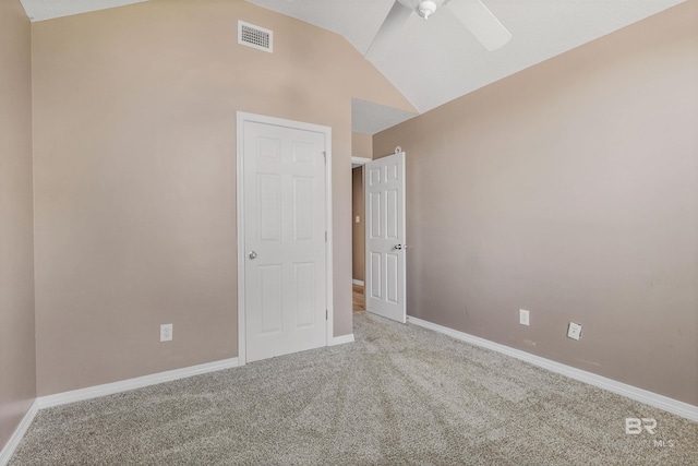 carpeted spare room featuring visible vents, baseboards, lofted ceiling, and a ceiling fan