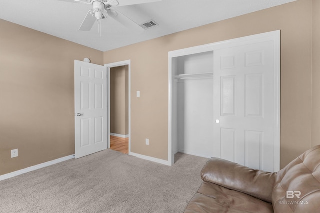 unfurnished bedroom with baseboards, visible vents, ceiling fan, a closet, and carpet flooring