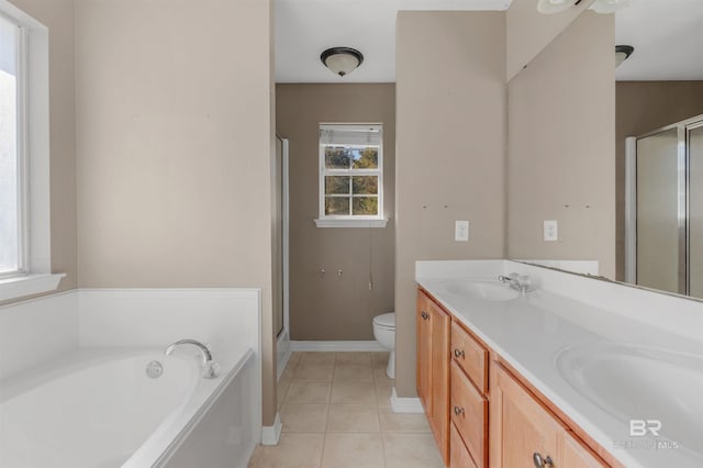 full bathroom featuring a garden tub, toilet, a sink, a shower stall, and tile patterned flooring