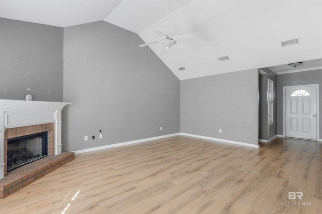 unfurnished living room featuring light wood finished floors, visible vents, a fireplace, and baseboards