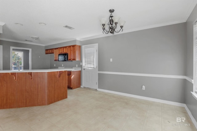 kitchen with visible vents, a breakfast bar, brown cabinetry, black microwave, and light countertops