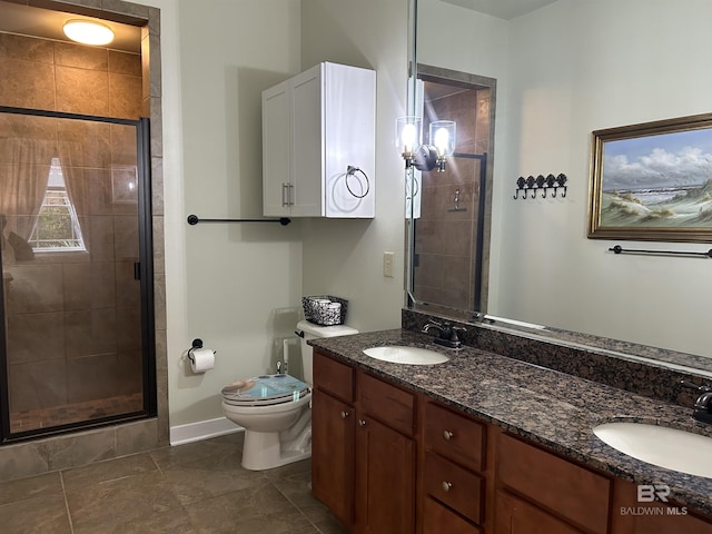 bathroom featuring double vanity, a stall shower, and a sink