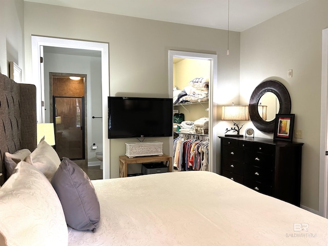 bedroom with ensuite bath, a closet, and a walk in closet