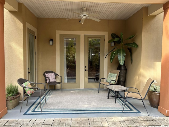 1430 Regency Rd Unit E102, Gulf Shores, AL 36542 - view of exterior entry with stucco siding and ceiling fan