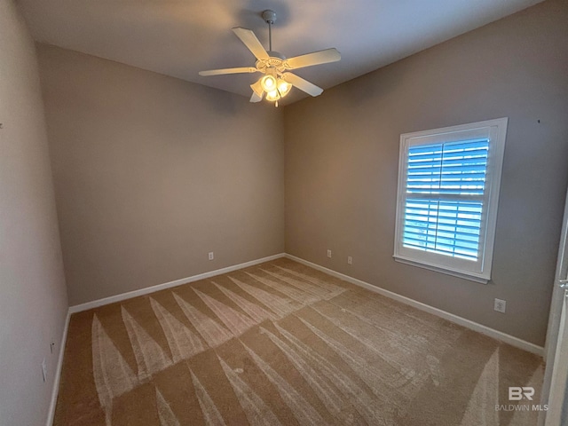 carpeted empty room featuring ceiling fan