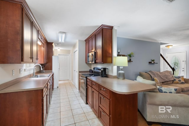 103 Hickory Ct, Daphne, AL 36526 - kitchen featuring stainless steel appliances, open floor plan, a sink, light tile patterned floors, and light countertops