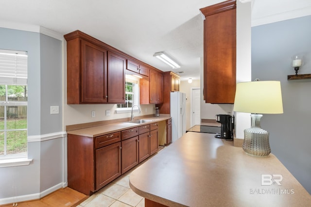 103 Hickory Ct, Daphne, AL 36526 - kitchen with a sink, white fridge with ice dispenser, light countertops, plenty of natural light, and crown molding