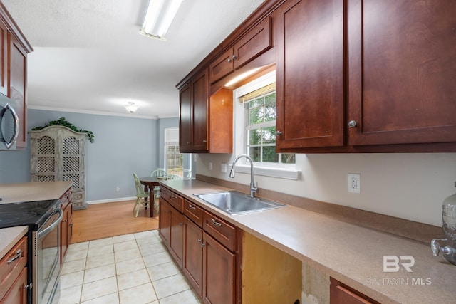 103 Hickory Ct, Daphne, AL 36526 - kitchen with a sink, stainless steel appliances, light countertops, ornamental molding, and light tile patterned flooring
