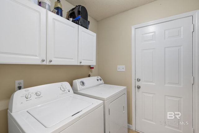 103 Hickory Ct, Daphne, AL 36526 - laundry room featuring washing machine and dryer, cabinet space, and a textured ceiling