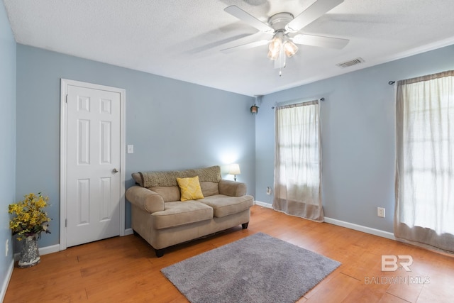 103 Hickory Ct, Daphne, AL 36526 - living area featuring a ceiling fan, light wood finished floors, baseboards, and a textured ceiling