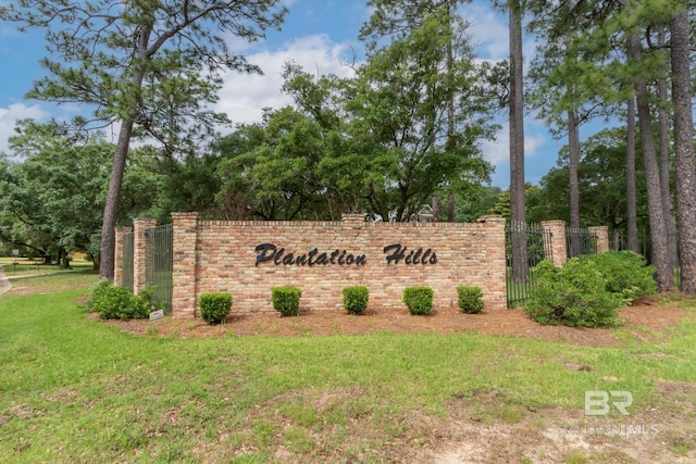 103 Hickory Ct, Daphne, AL 36526 - community sign with a yard and view of wooded area