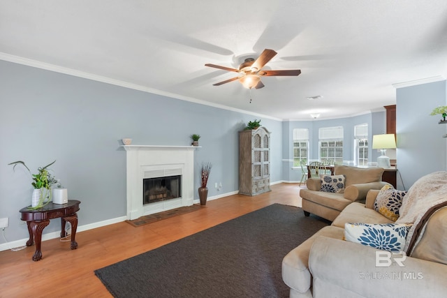 103 Hickory Ct, Daphne, AL 36526 - living room with crown molding, a ceiling fan, wood finished floors, baseboards, and a fireplace with flush hearth