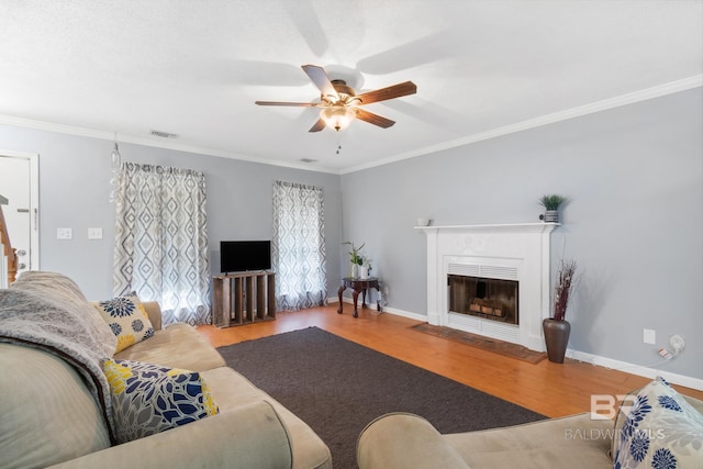 103 Hickory Ct, Daphne, AL 36526 - living room with ceiling fan, wood finished floors, ornamental molding, a fireplace with flush hearth, and baseboards