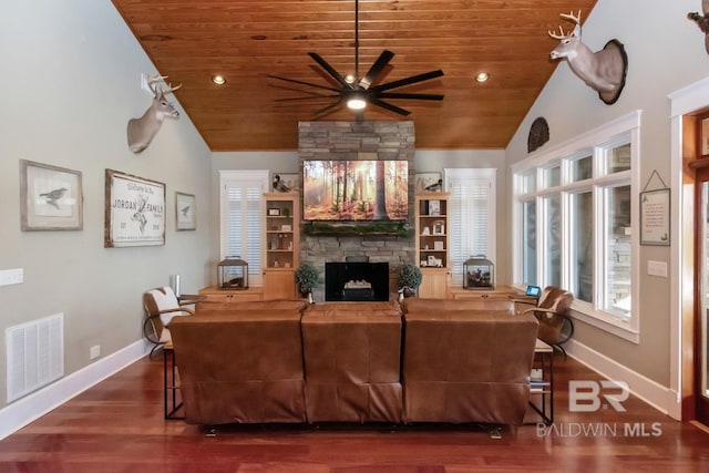 living room featuring wood finished floors, visible vents, a fireplace, ceiling fan, and wood ceiling