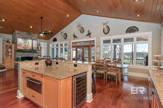 kitchen with ceiling fan, light brown cabinetry, wine cooler, wooden ceiling, and a warming drawer