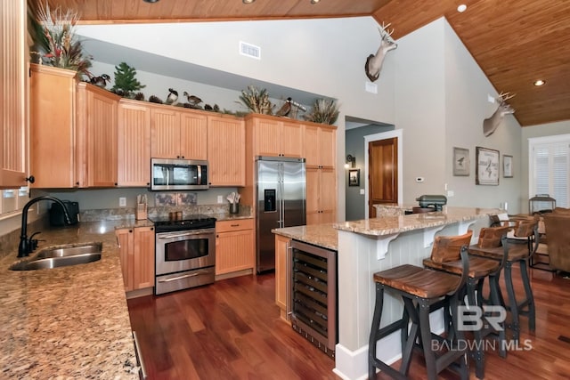 kitchen with beverage cooler, a sink, dark wood-style floors, stainless steel appliances, and wood ceiling