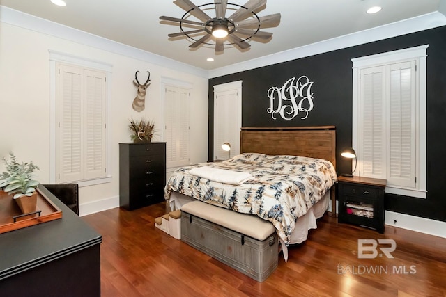 bedroom featuring recessed lighting, wood finished floors, baseboards, and ornamental molding