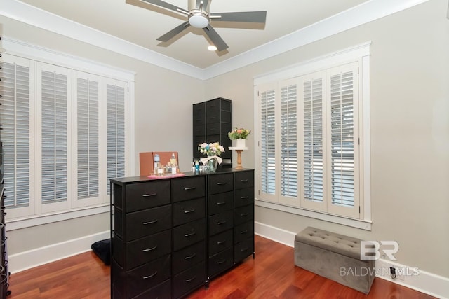 bedroom with ceiling fan, crown molding, baseboards, and dark wood-style flooring