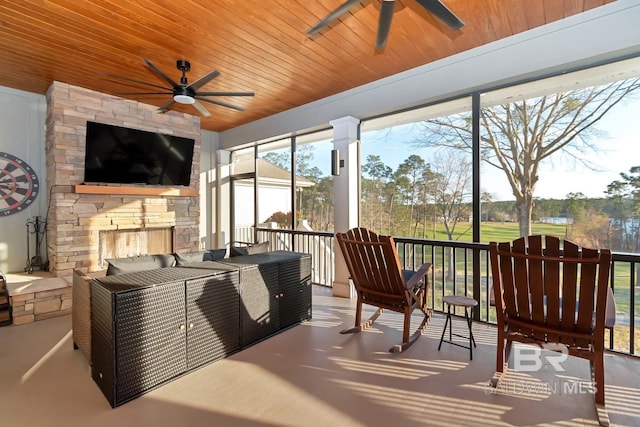 sunroom featuring wooden ceiling and ceiling fan