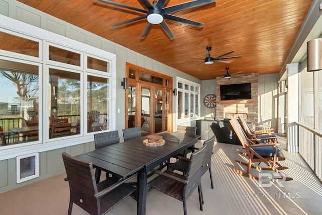 exterior space featuring french doors, outdoor dining space, and a ceiling fan