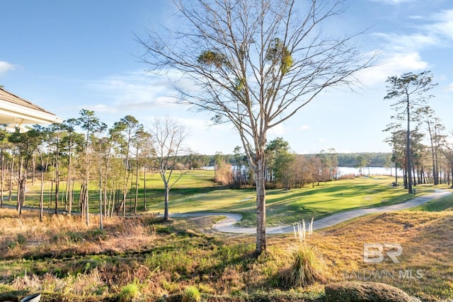 view of home's community with a yard and view of golf course