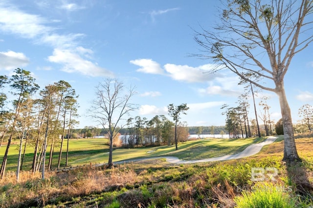 view of home's community featuring a lawn and view of golf course