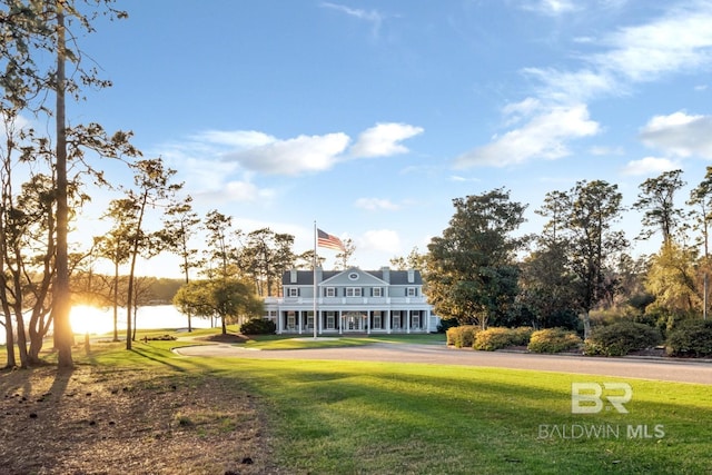 exterior space featuring a yard and a water view