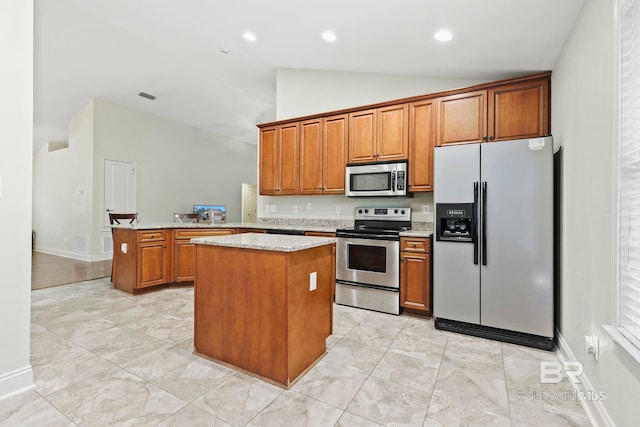 kitchen with stainless steel appliances, high vaulted ceiling, light stone countertops, a kitchen island, and kitchen peninsula