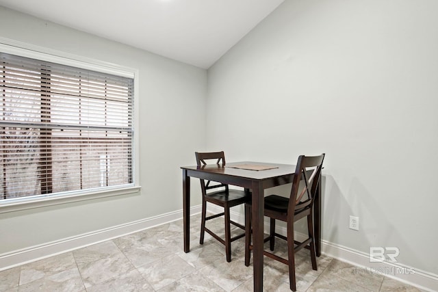 dining space with vaulted ceiling