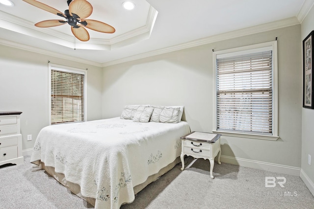 bedroom with a raised ceiling, ornamental molding, carpet flooring, and ceiling fan