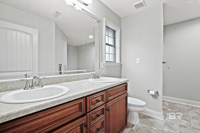 bathroom with vanity and toilet