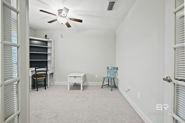 interior space with carpet flooring and ceiling fan