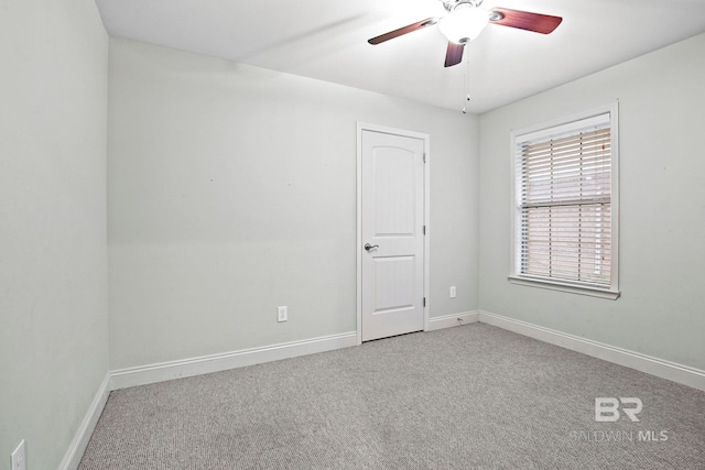 spare room with carpet floors and ceiling fan